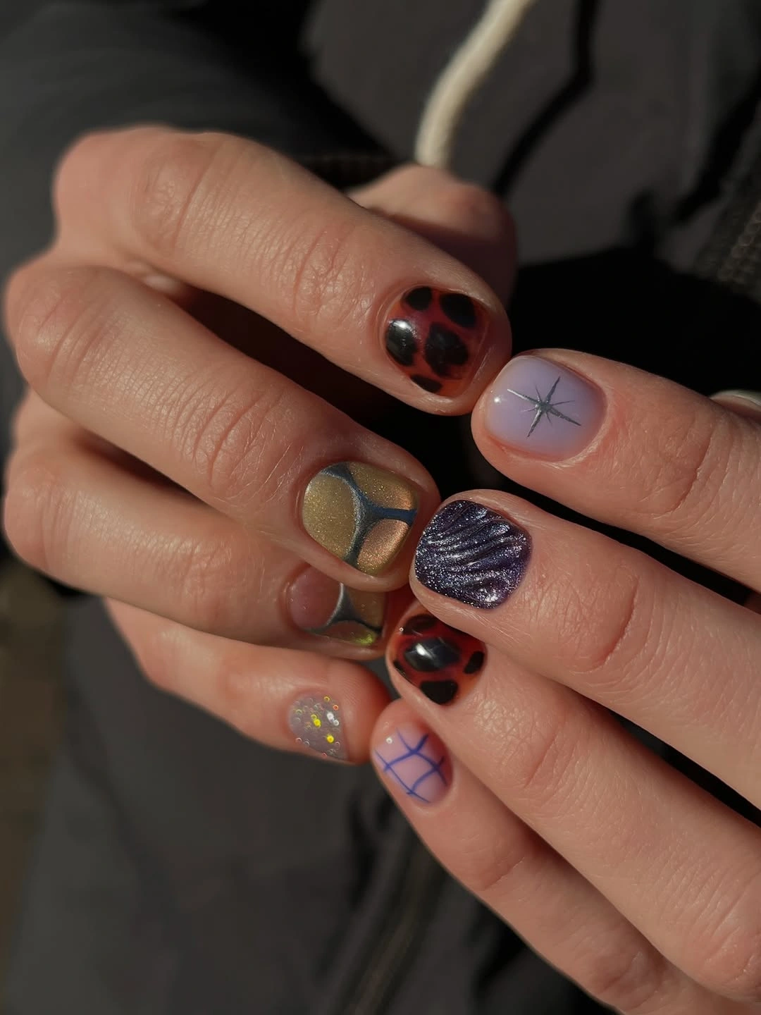 short nude nails with plaid lines dots and tiny doodles