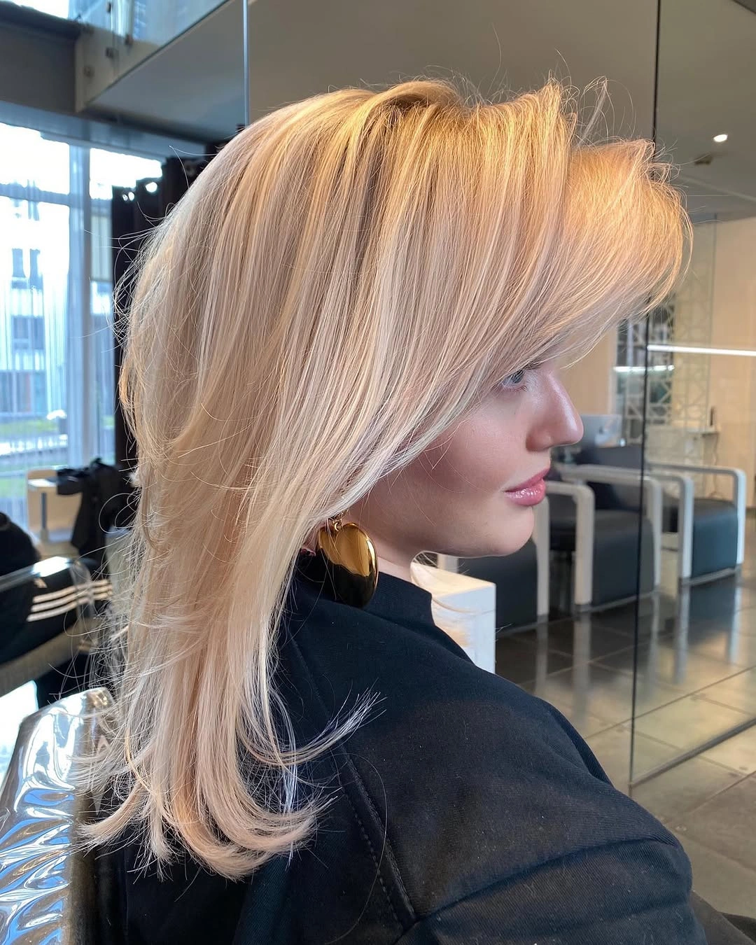 fall medium haircuts 2026 Feathered Blonde Volume With A Luxurious Finish