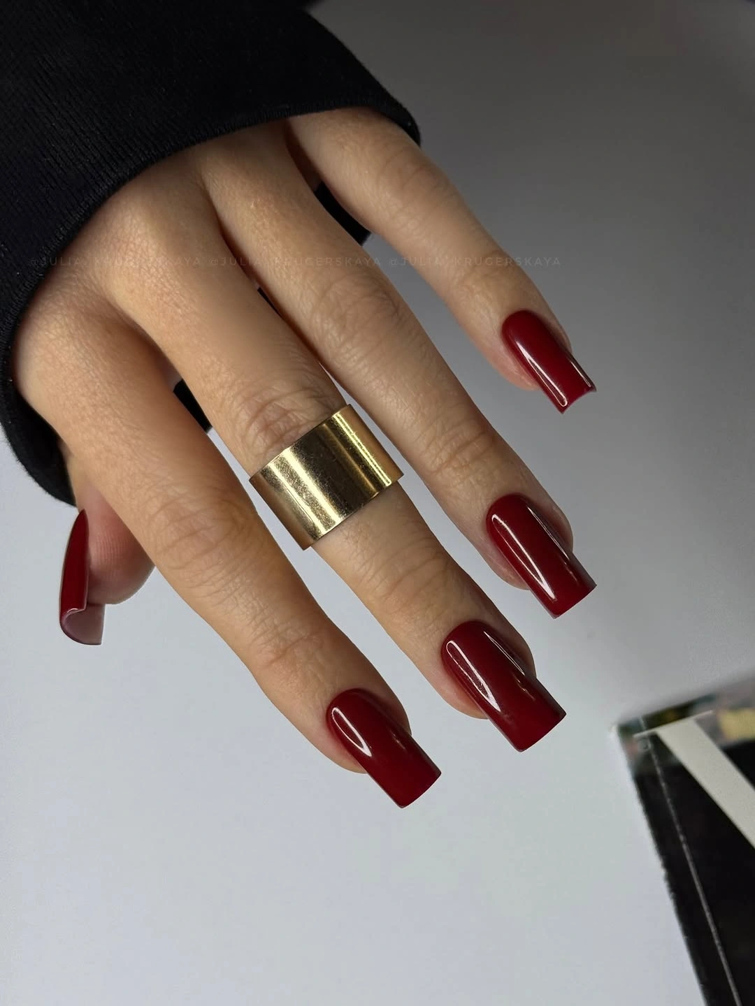Glossy burgundy medium square nails with clean edges