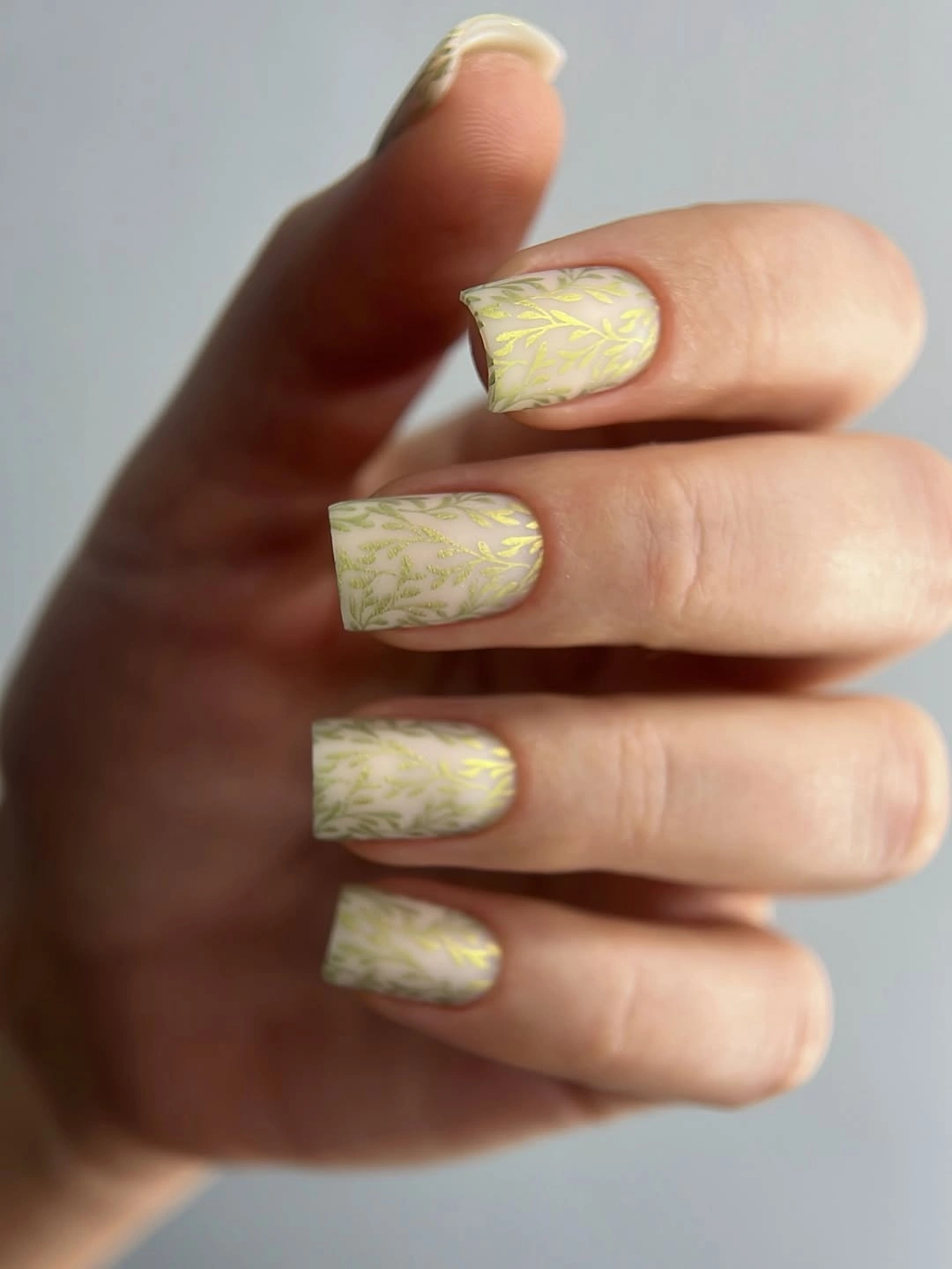 Cream square nails with pale gold leaf pattern