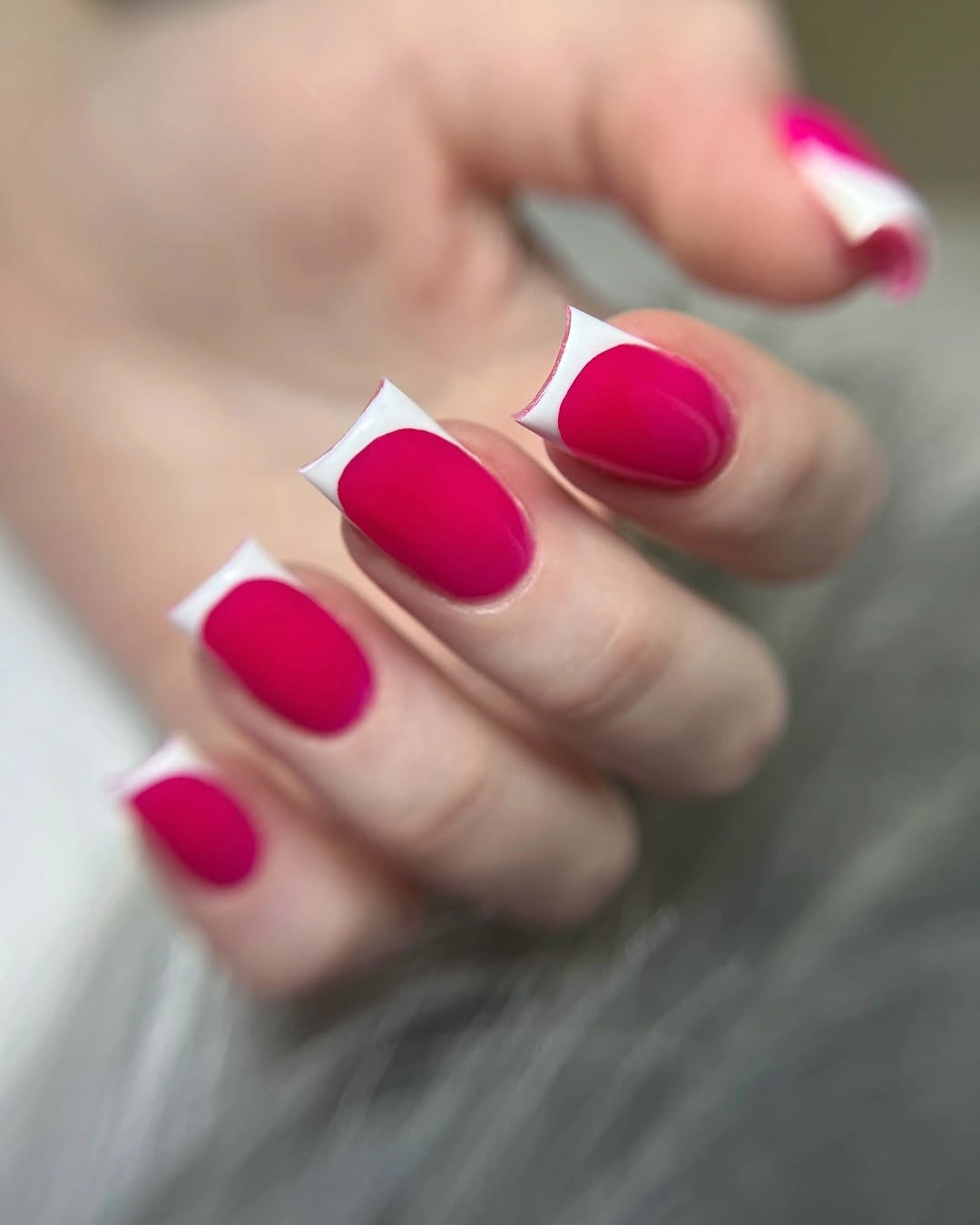 Magenta square nails with white angled French corners