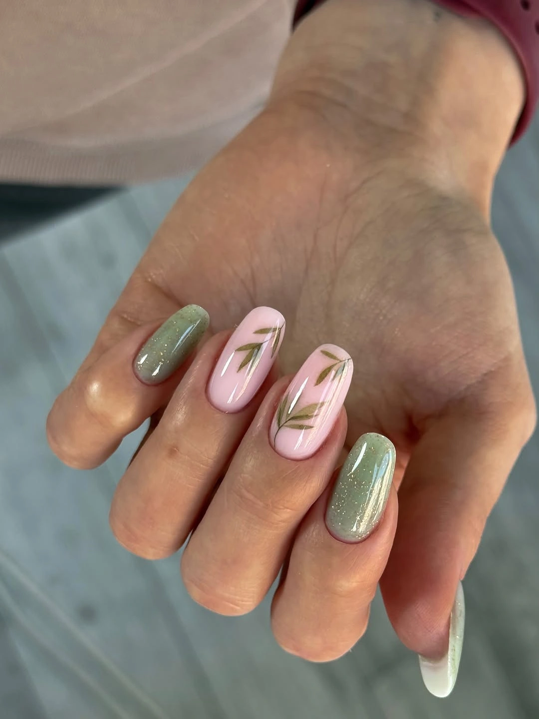 Sage sparkle almond nails with pink leaf accents