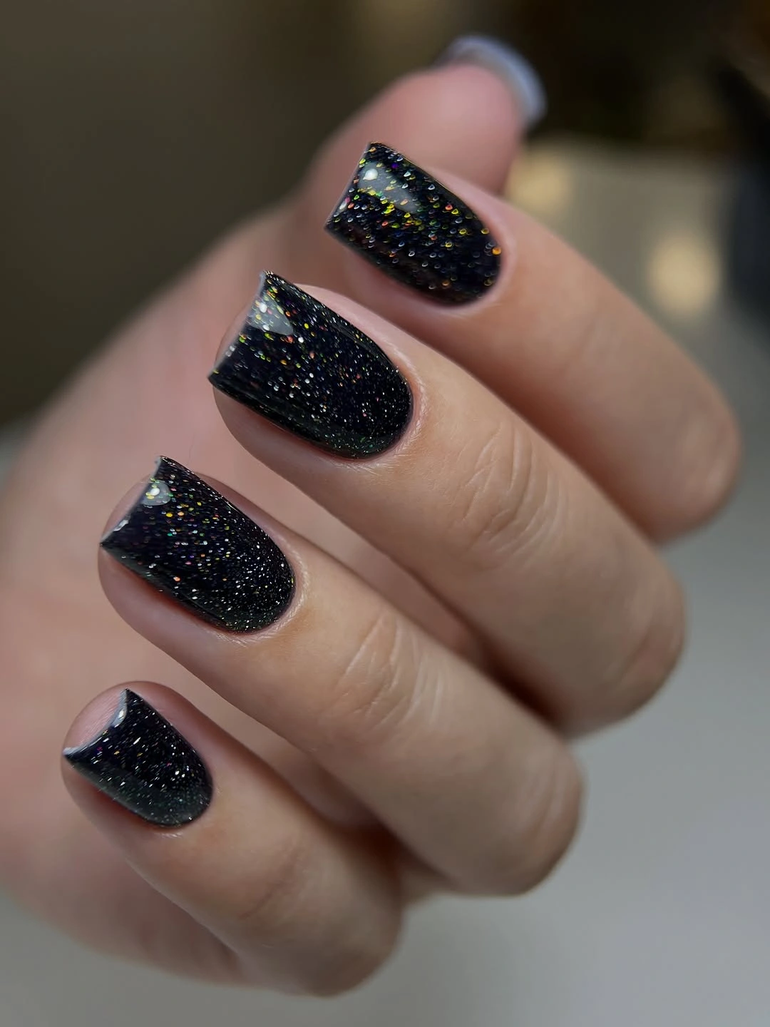 Black glitter square nails with tiny rainbow flecks