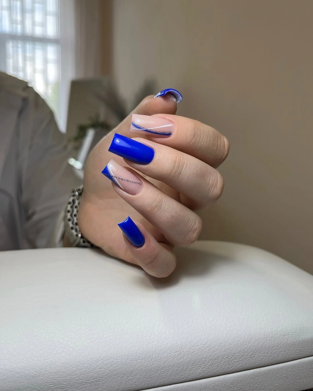 Cobalt square nails with nude and silver accent lines