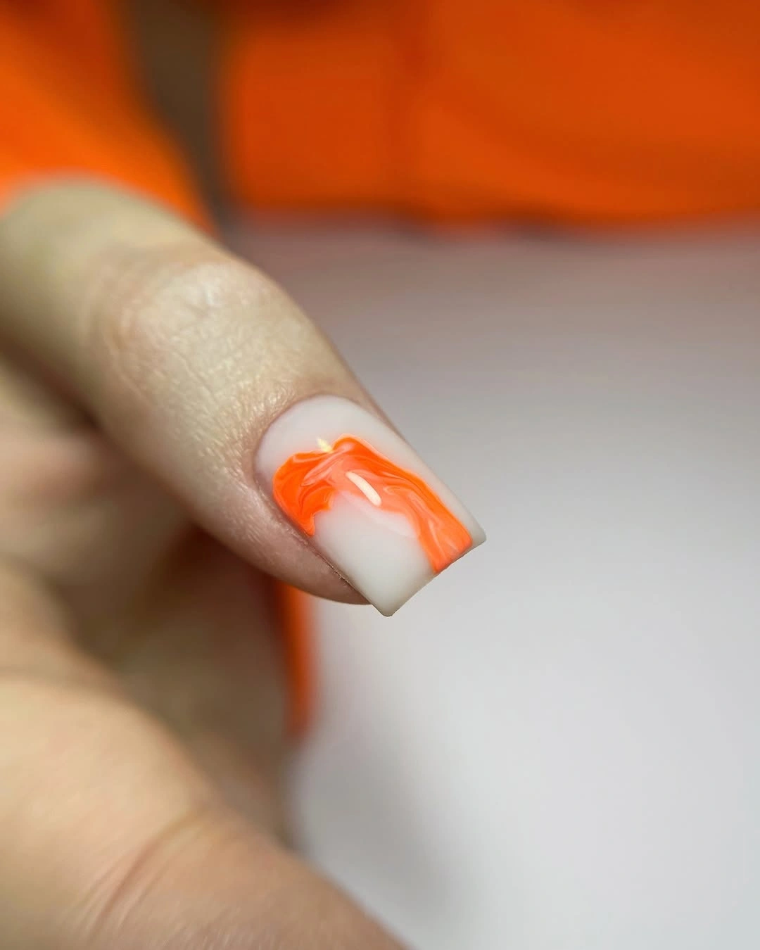 Single milky square nail with orange marble accent