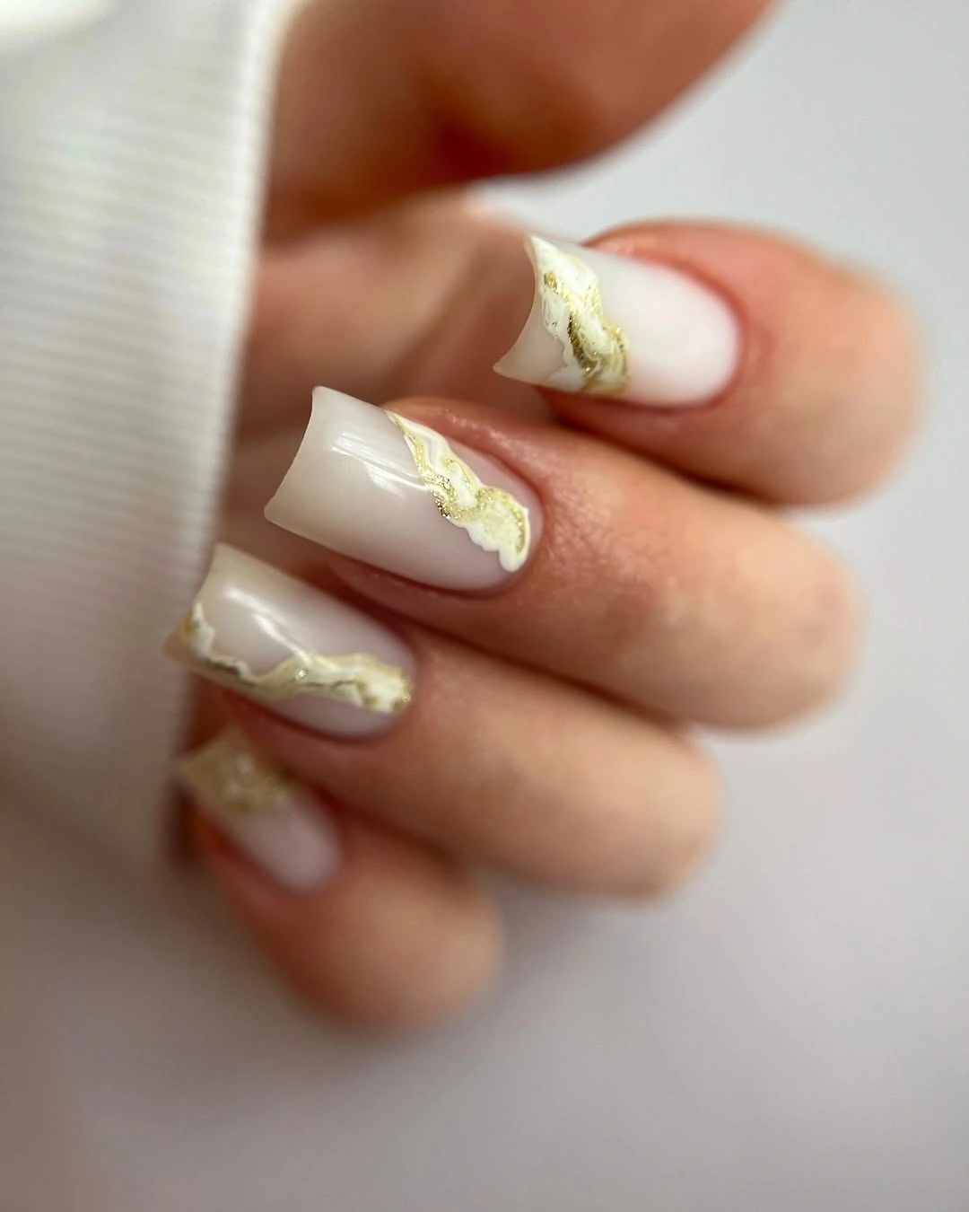 Ivory square nails with raised pale gold ribbon accents
