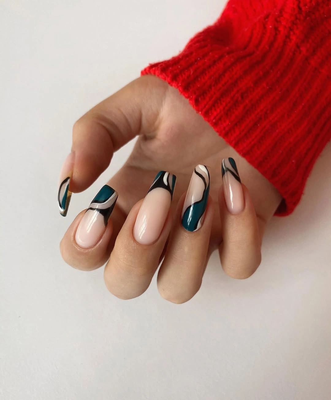 Almond nails with teal black and nude abstract lines