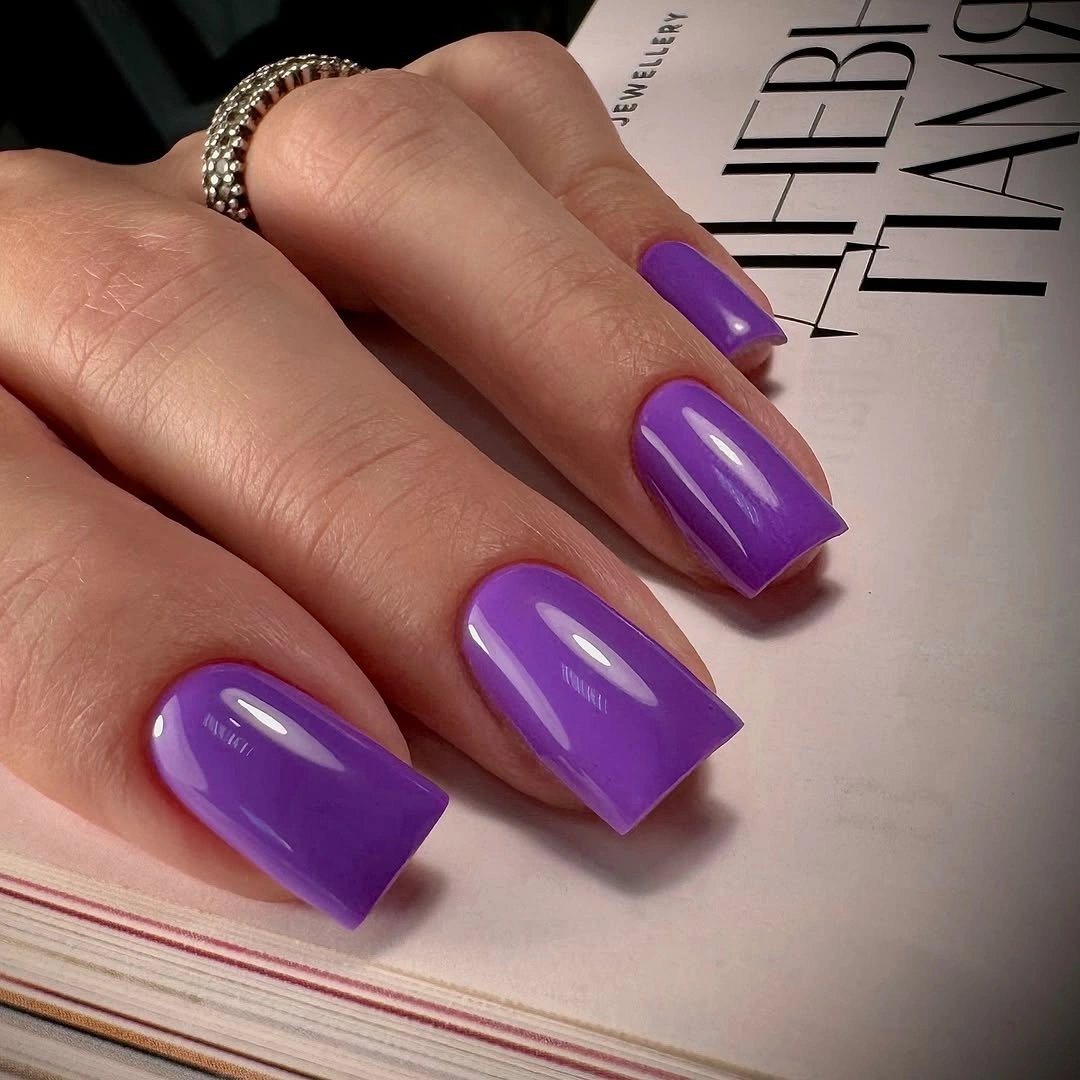 Glossy purple square nails with clean medium corners