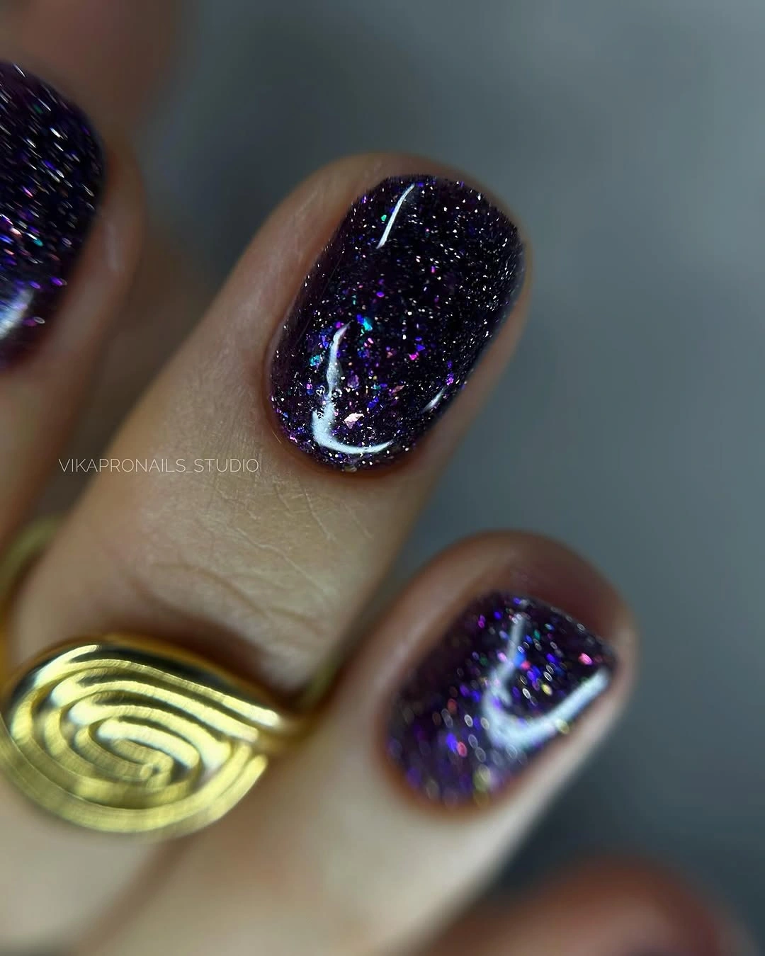 Dark purple glitter nails with tiny crescent moon accent