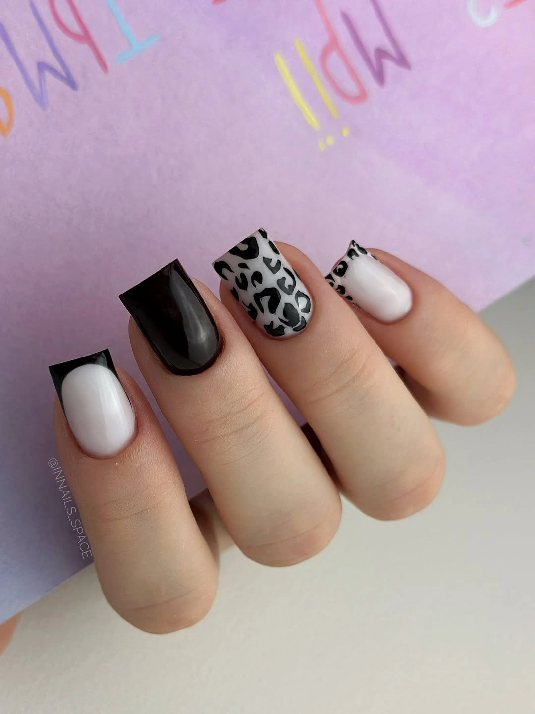 Square black and white nails with leopard accent pattern