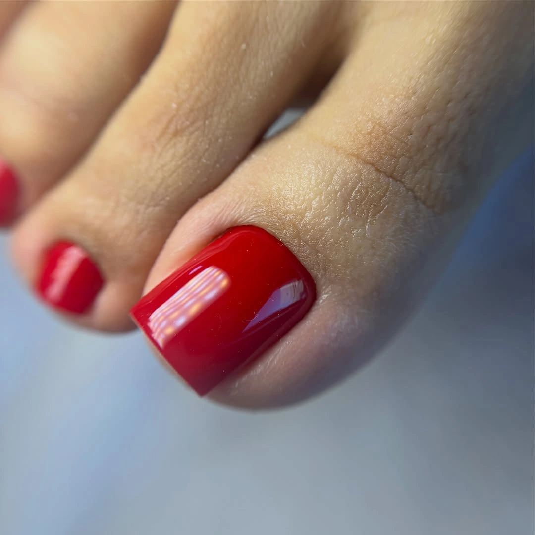 clean red polish on sharp square toenails