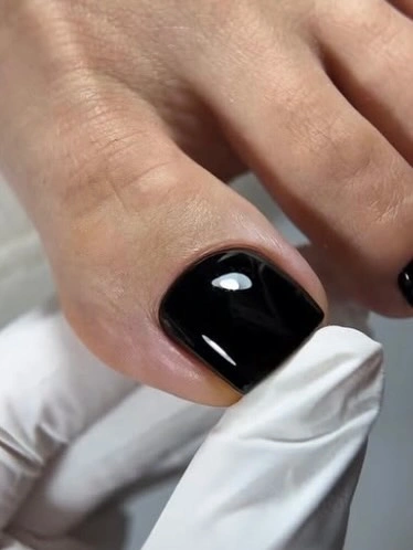 inky black polish on a short square big toe