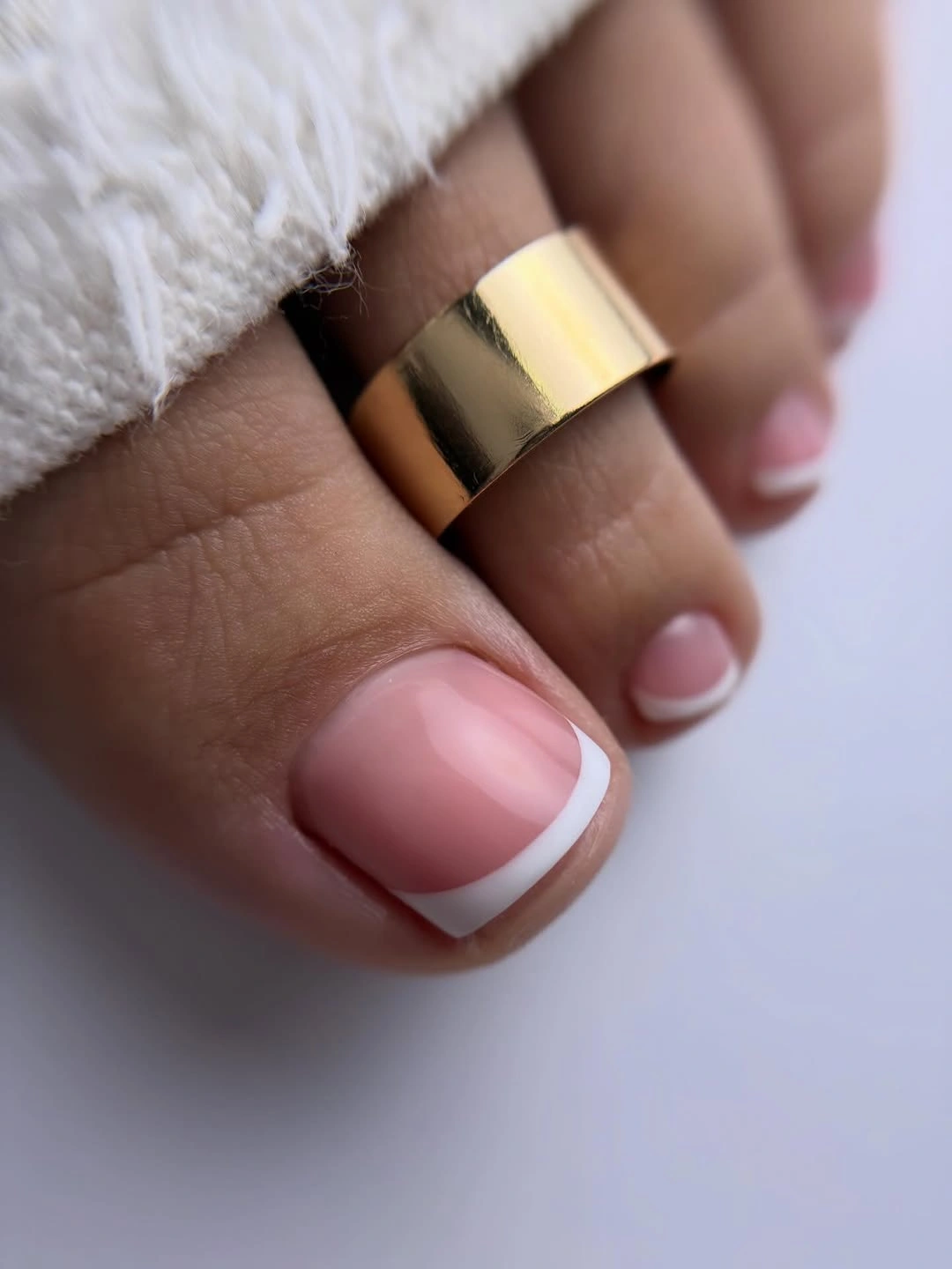 sheer pink French tips with gold toe band
