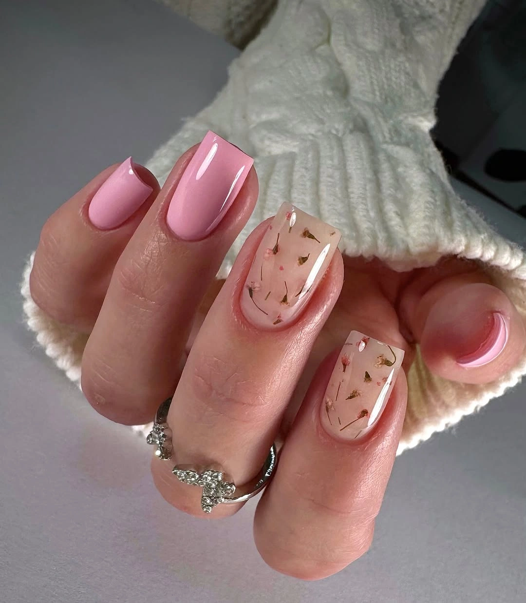 pink short nails with nude speckled accent panels