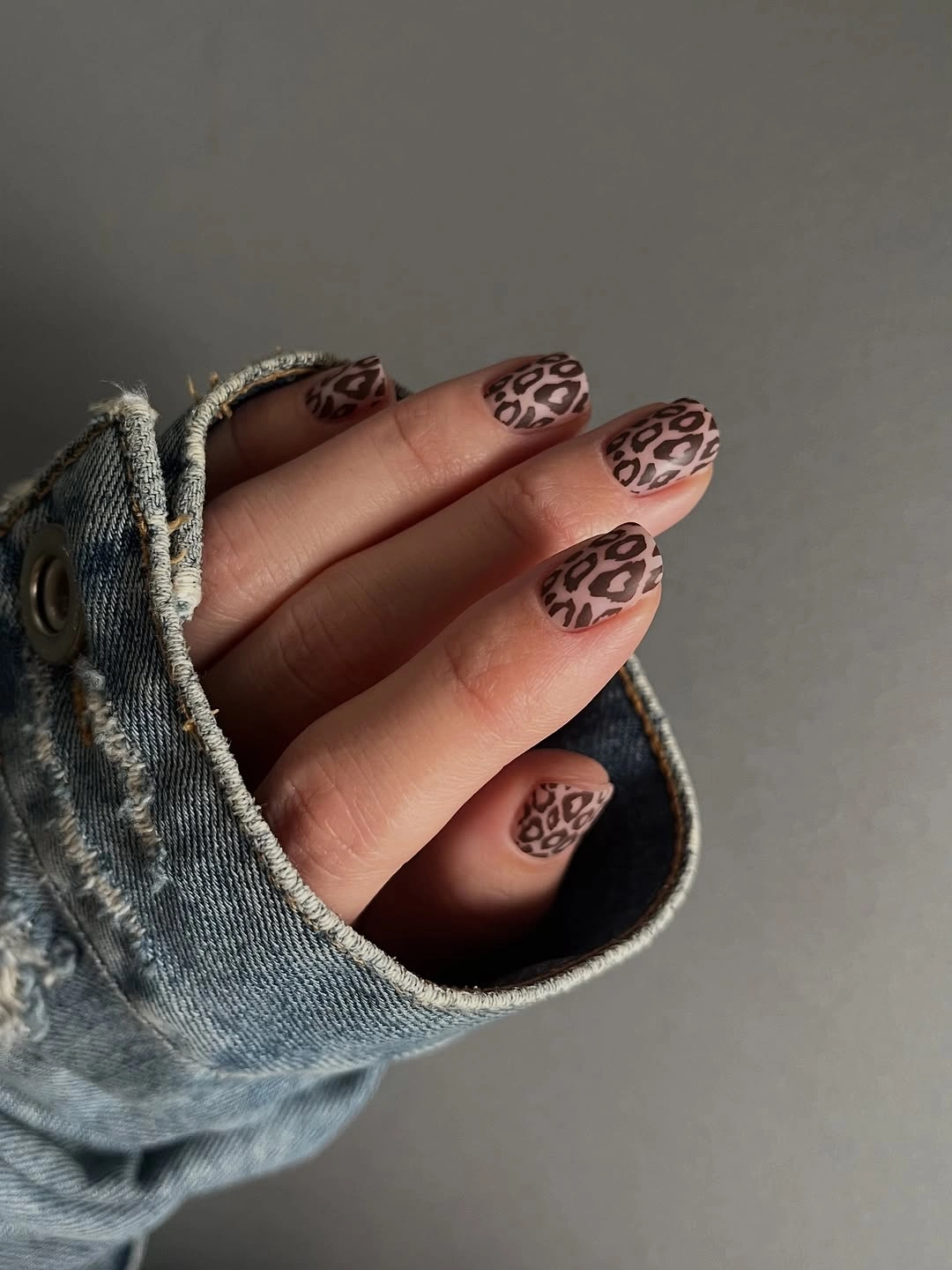 short leopard print nails styled with denim