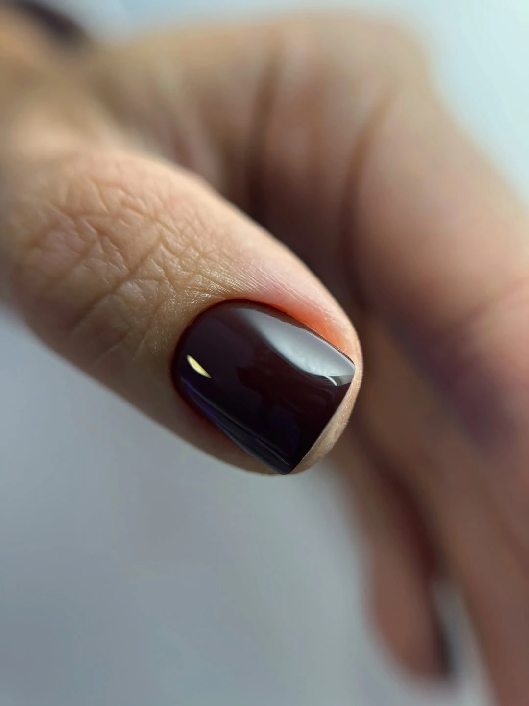 burgundy short nail with gray diagonal accent