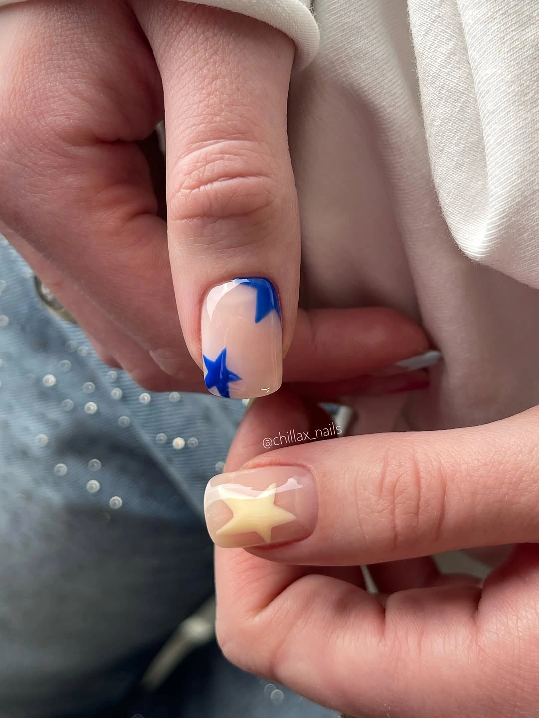 nude short nails with blue star accents