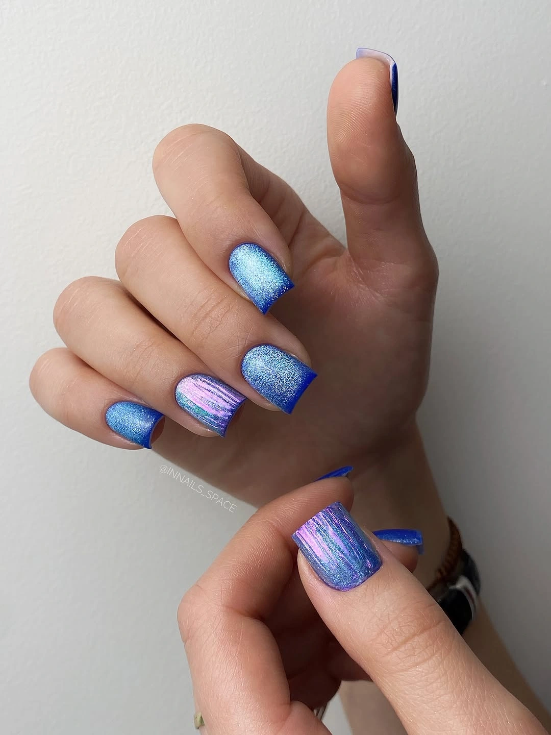 blue shimmer short nails with one striped accent