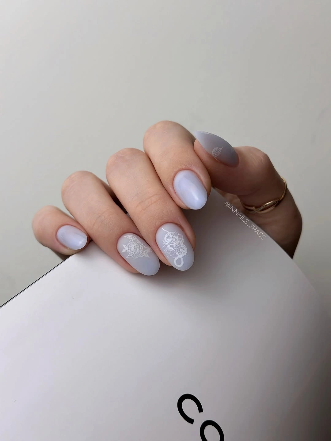pale blue short nails with white glitter accents