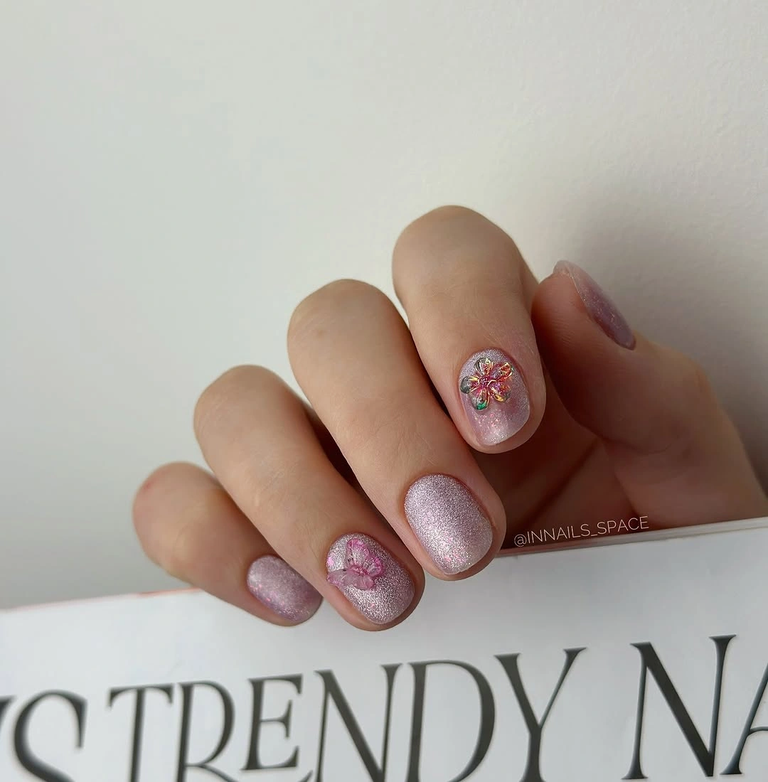 pink glitter short nails with tiny floral accent