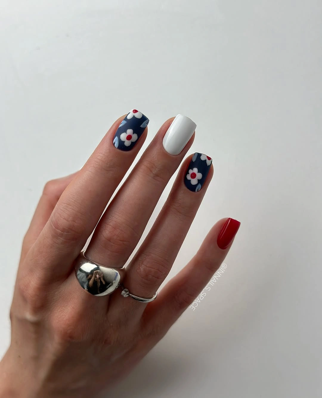 navy floral short nails with red and white accents