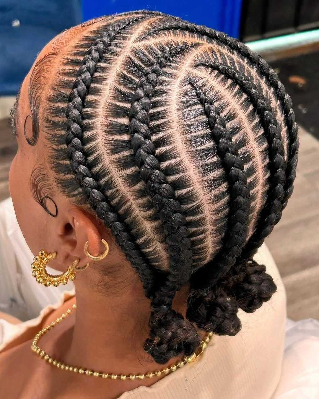 feed in braid hairstyles Feathered Feed-In Braids with a Sleek Low Double Bun