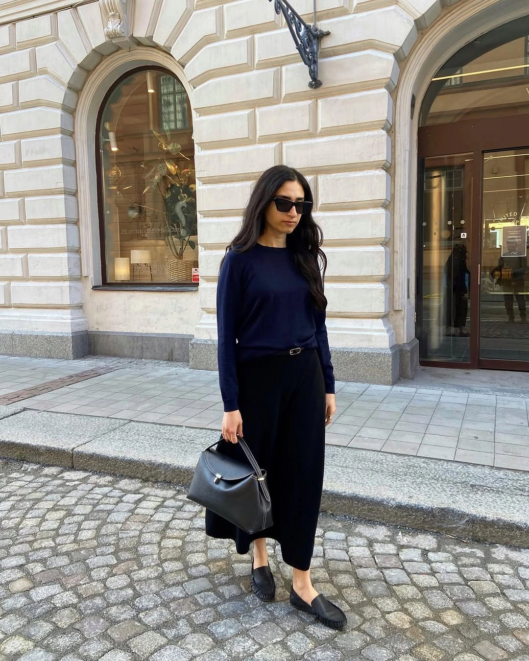 midi skirt fall outfit 2026 Minimalist Navy Knit with a Flowing Black Midi Skirt