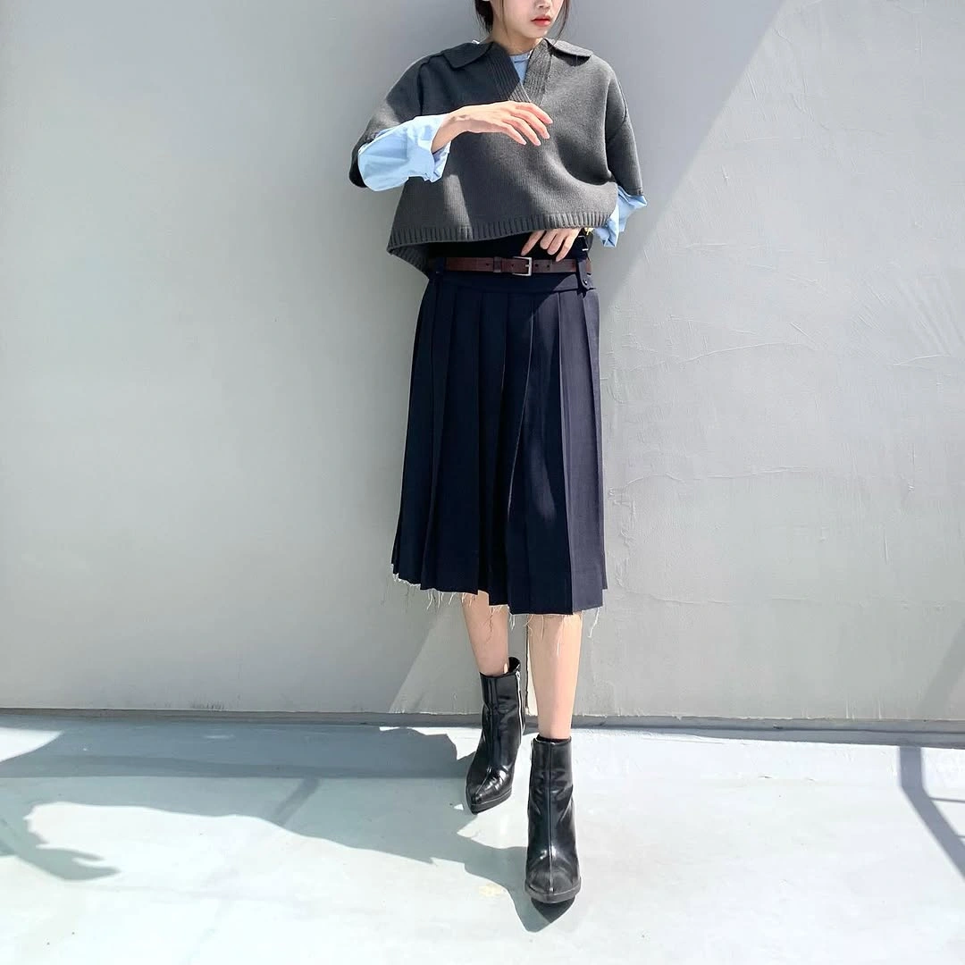 midi skirt fall outfit 2026 Modern Layering with a Black Pleated Midi and Ankle Boots