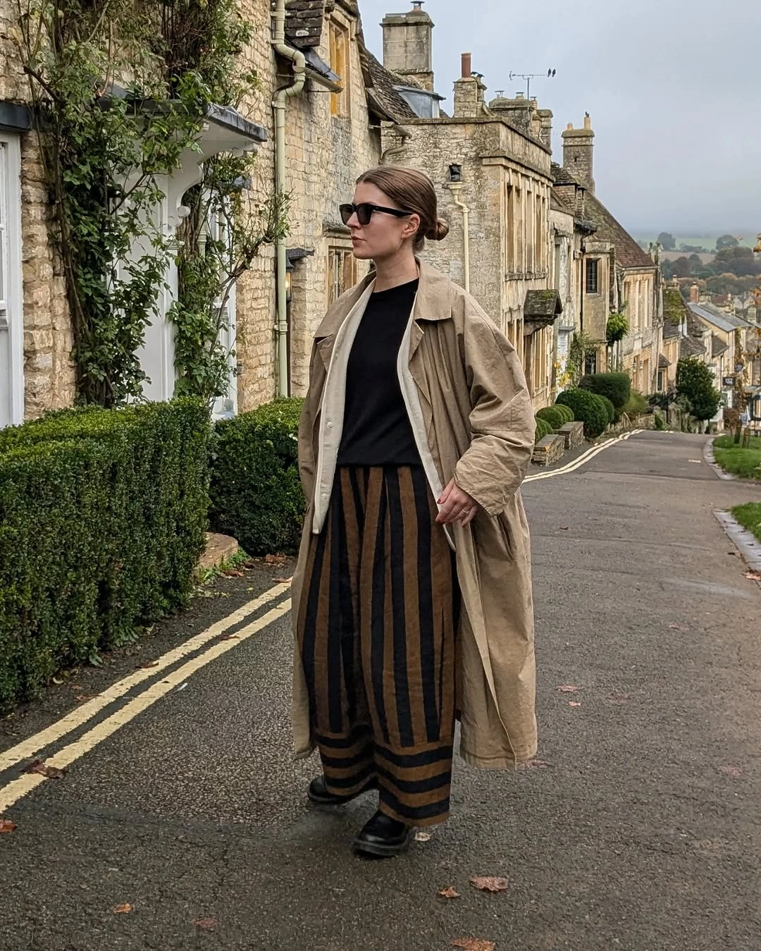 September fashion trends 2026 Beige Trench Over Black And Striped Skirt