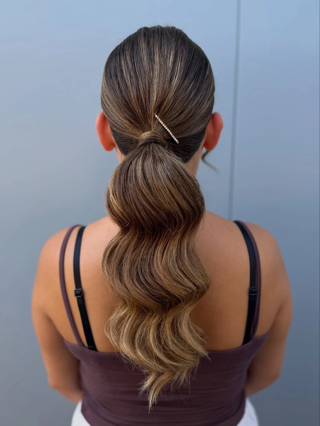 September hairstyles ideas 2026 Low Wavy Ponytail With Wrapped Center