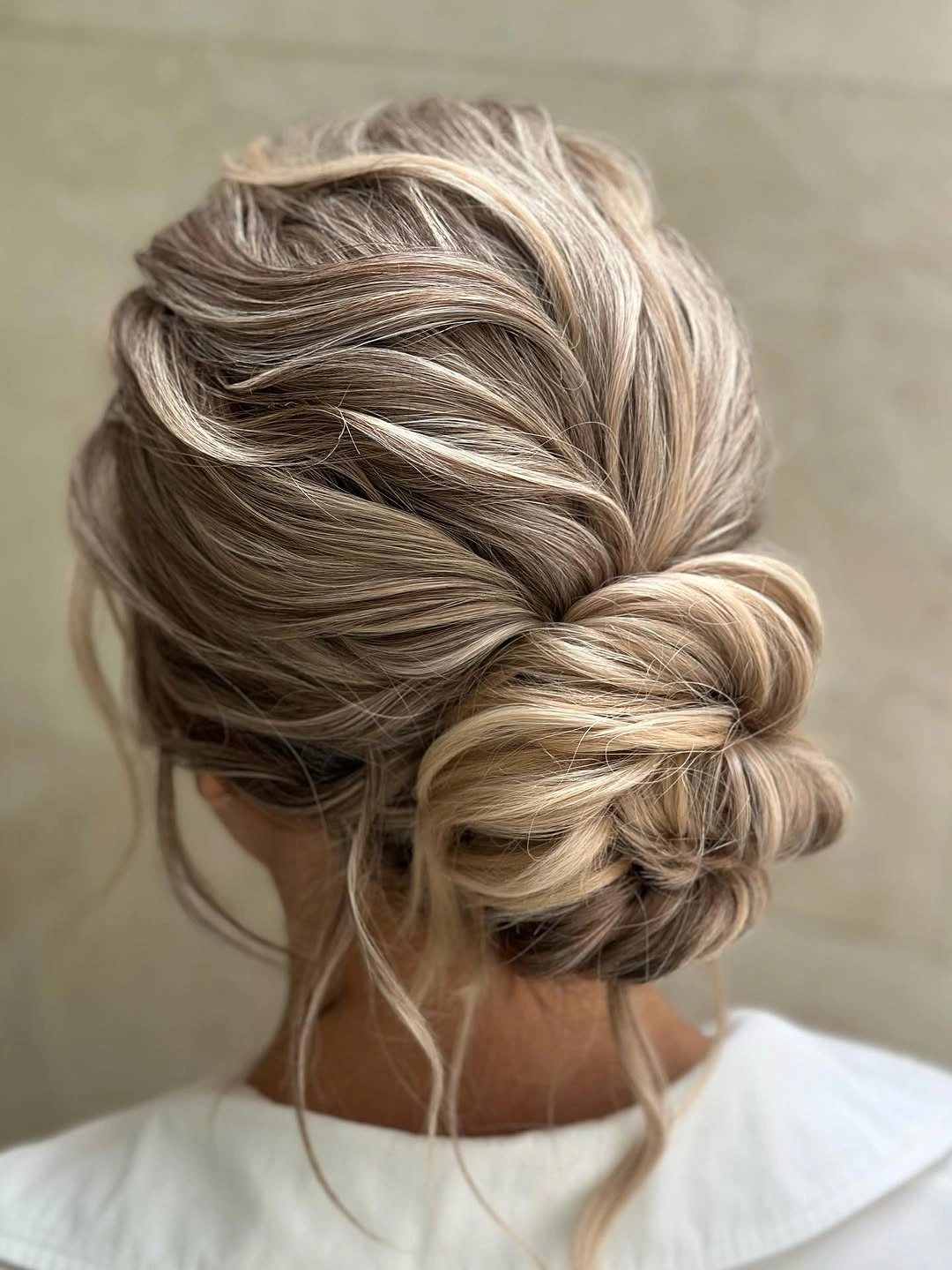 September hairstyles ideas 2026 Braided Low Bun With Soft Strands