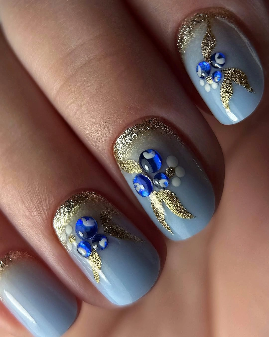 September nail art ideas 2026 Baby Blue Nails With Gold Glitter And Blue Gems