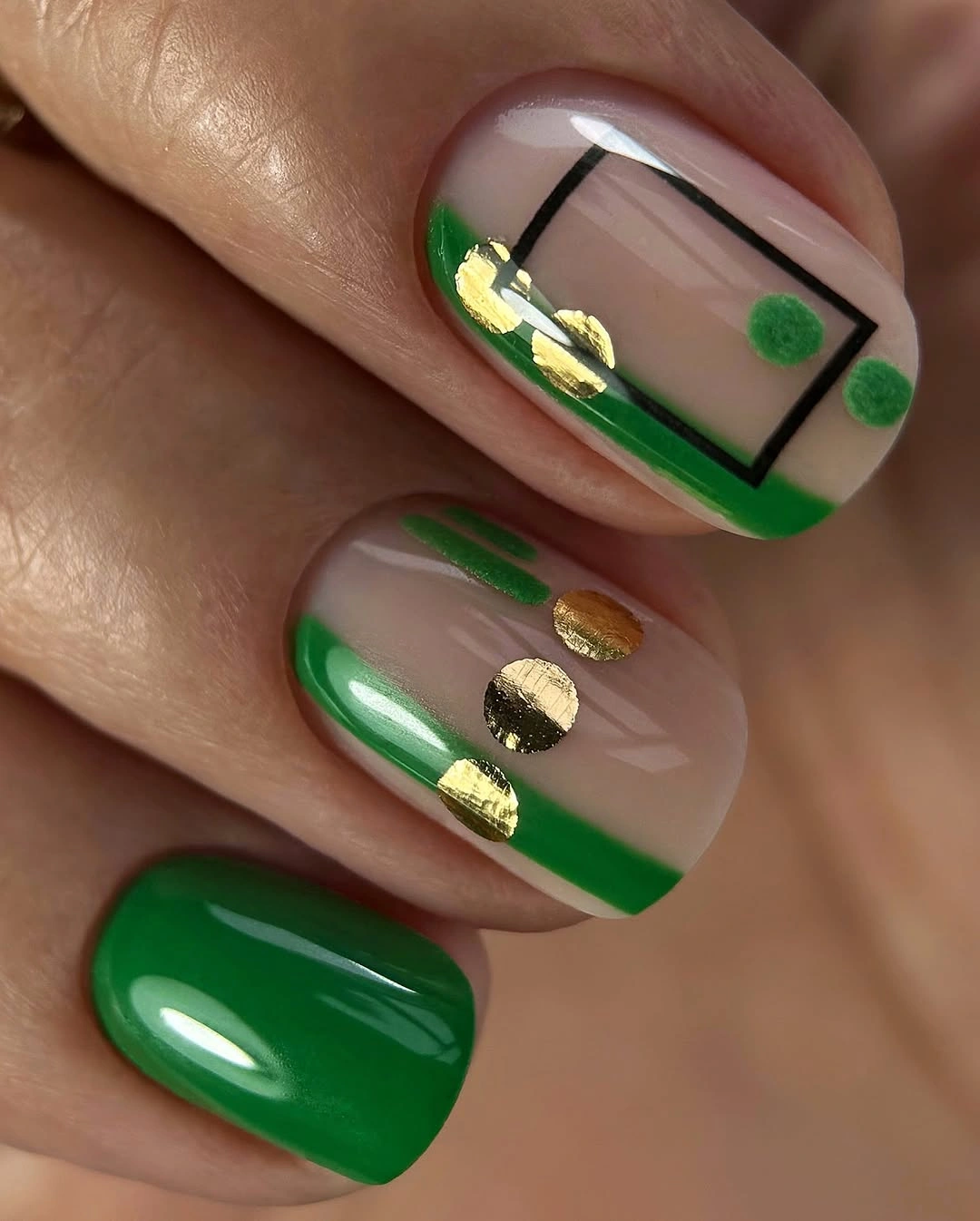 September nail art ideas 2026 Green Nails With Black Geometric Lines And Gold Foil