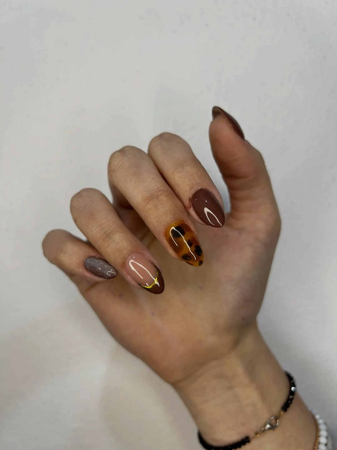 September nails color 2026 Brown Tortoise Almond Nails With Metallic Gold Lines