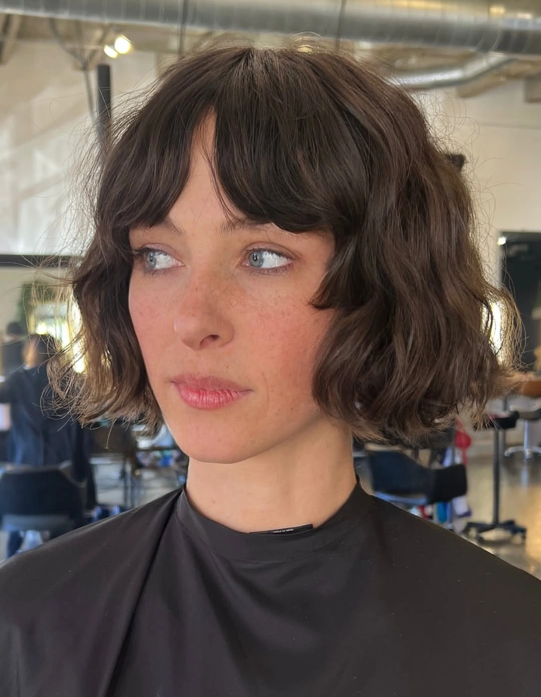 short bobbed hairstyle French-Inspired Wavy Bob with Soft Curtain Bangs