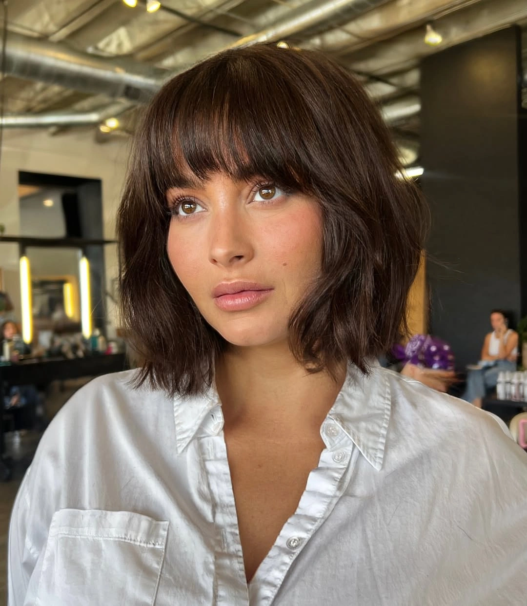 short bobbed hairstyle Soft Chocolate Bob with Full Feathered Fringe