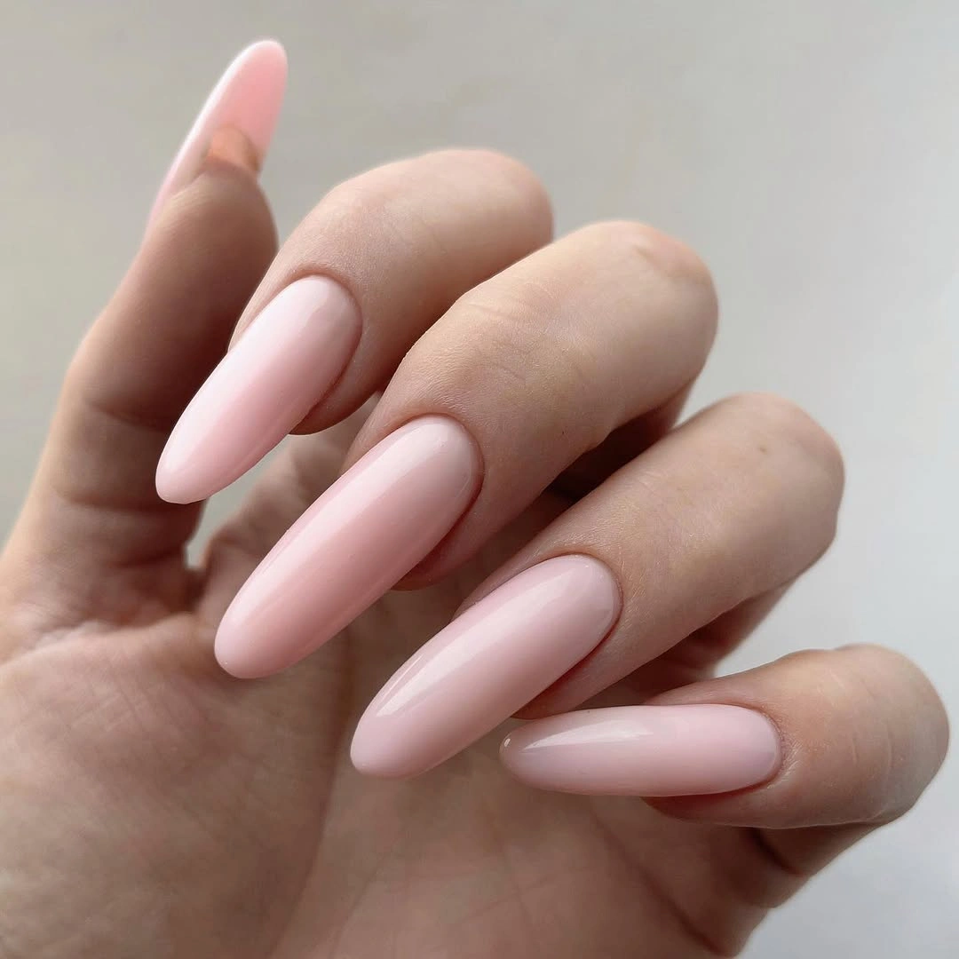Long pale pink almond nails with a clean uniform finish