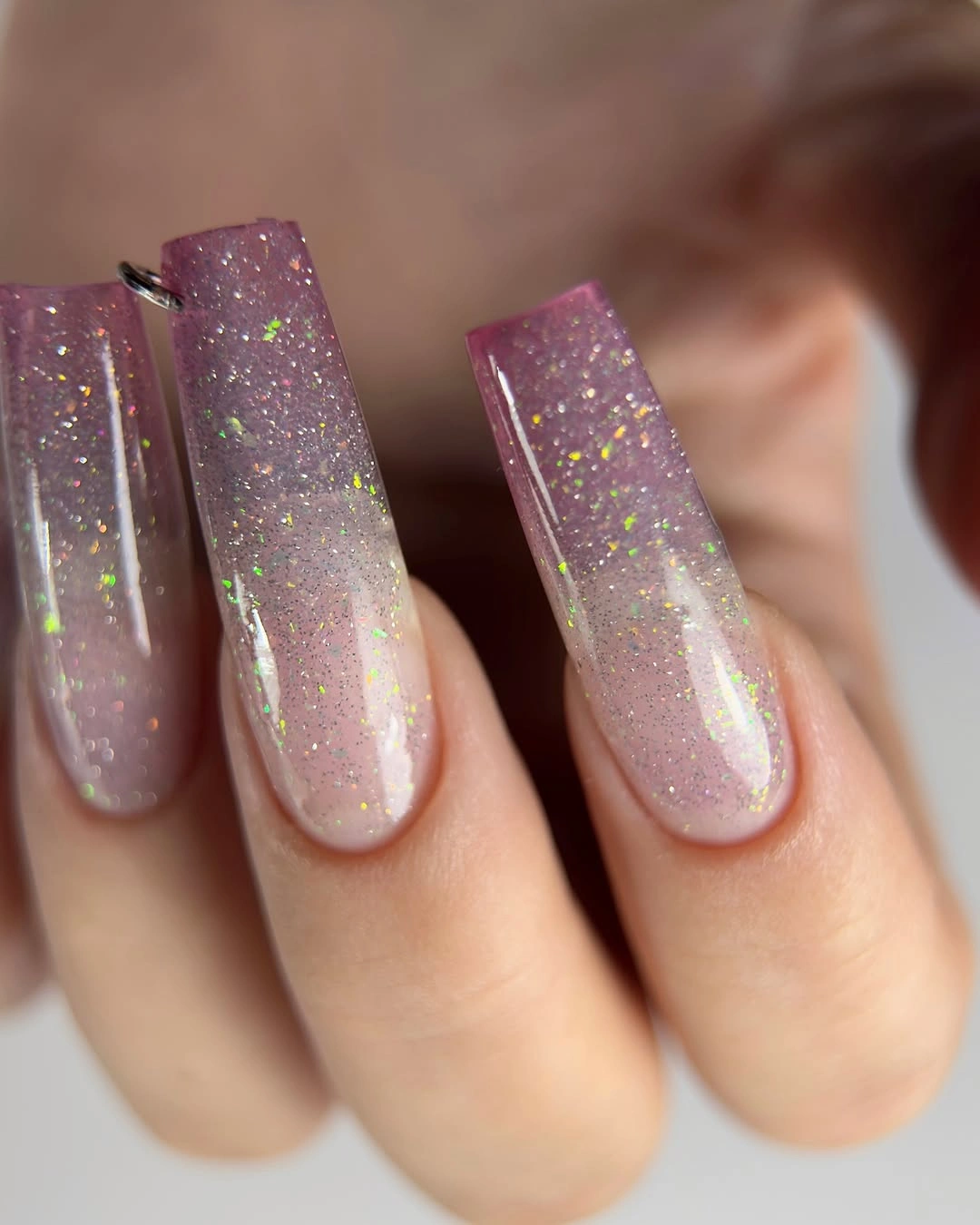 Long square nails with sheer pink glitter and iridescent flecks