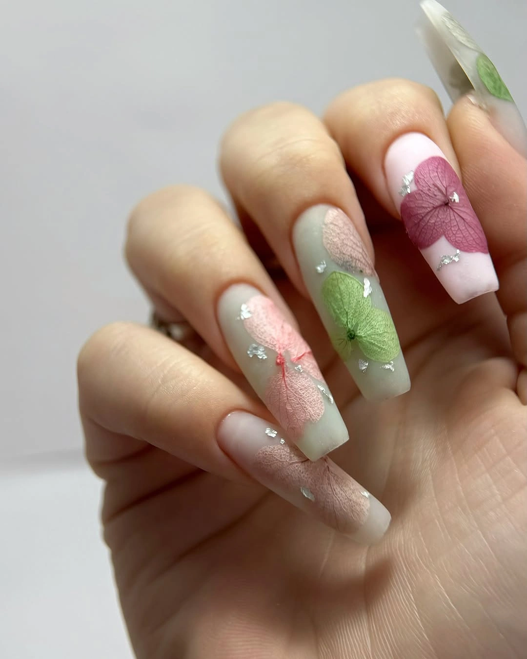 Long square pastel nails with pink green and mauve color blocks