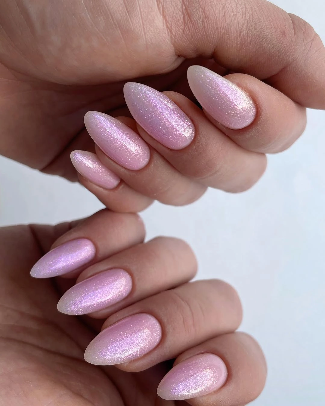 Medium almond nails with soft pink pearly shimmer