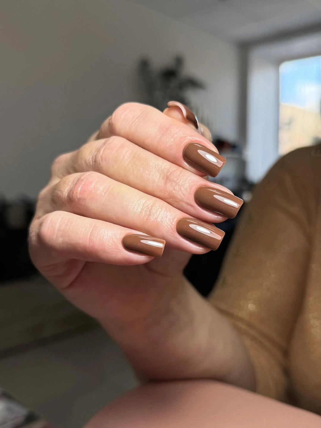 Long brown square nails with irregular gold-edged accents