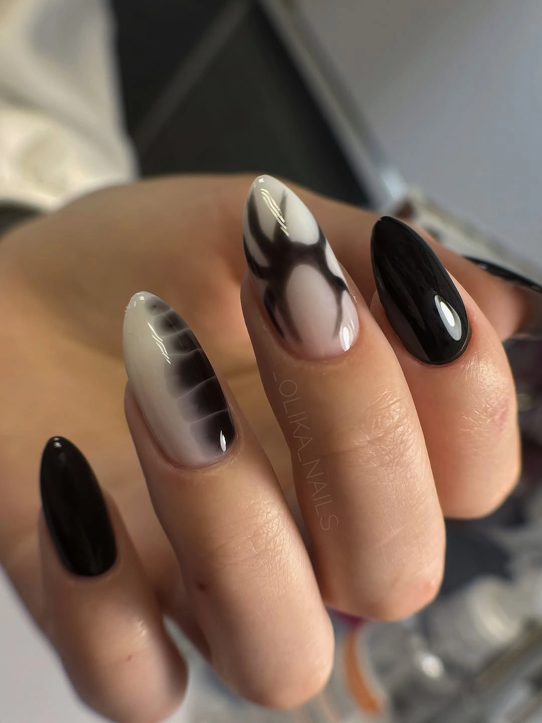 Long almond nails mixing solid black and smoky gray accents