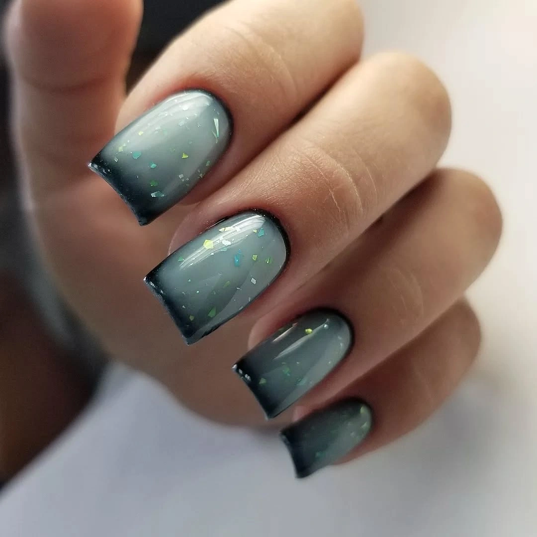 Short square smoky blue-gray nails with dark edges and light flakes