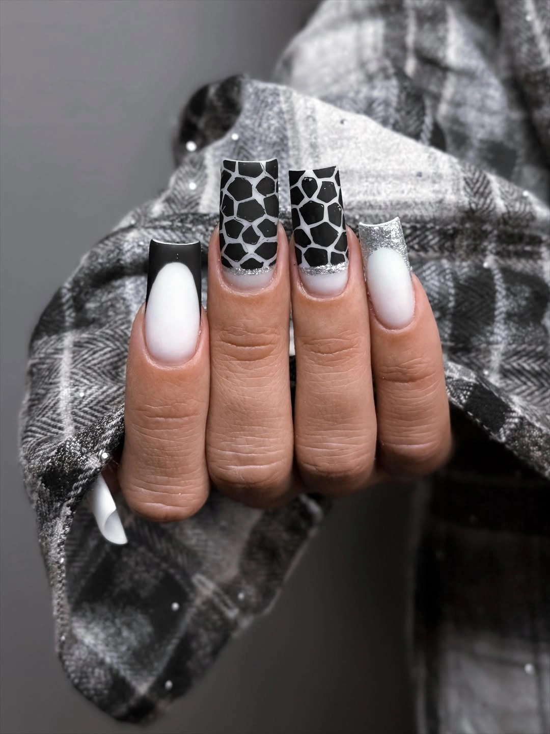 Long square nails with irregular black and white patterned accents