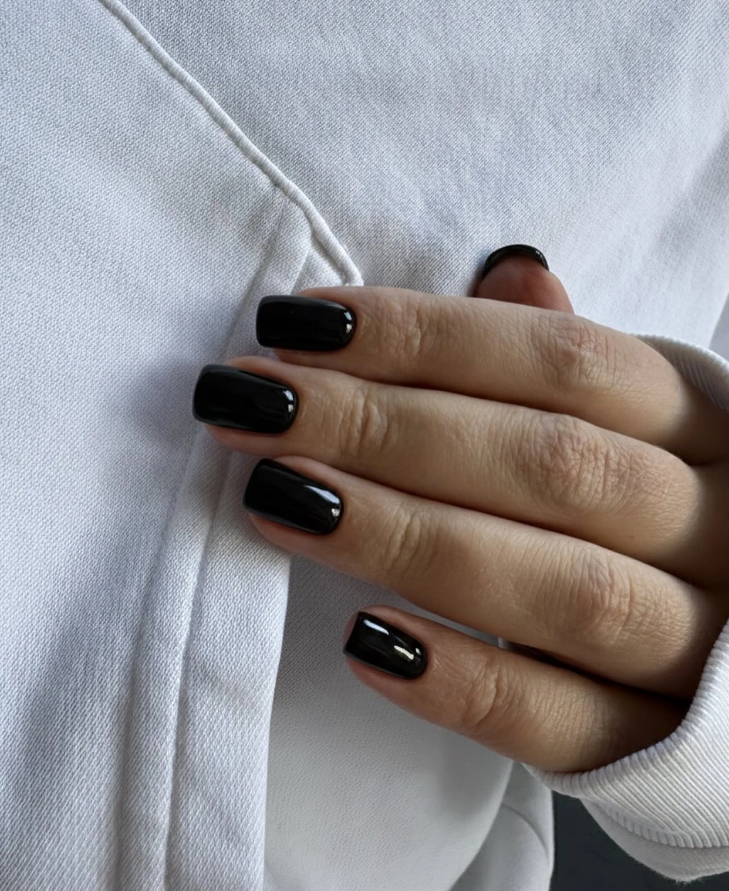 Short square nails in a uniform glossy black