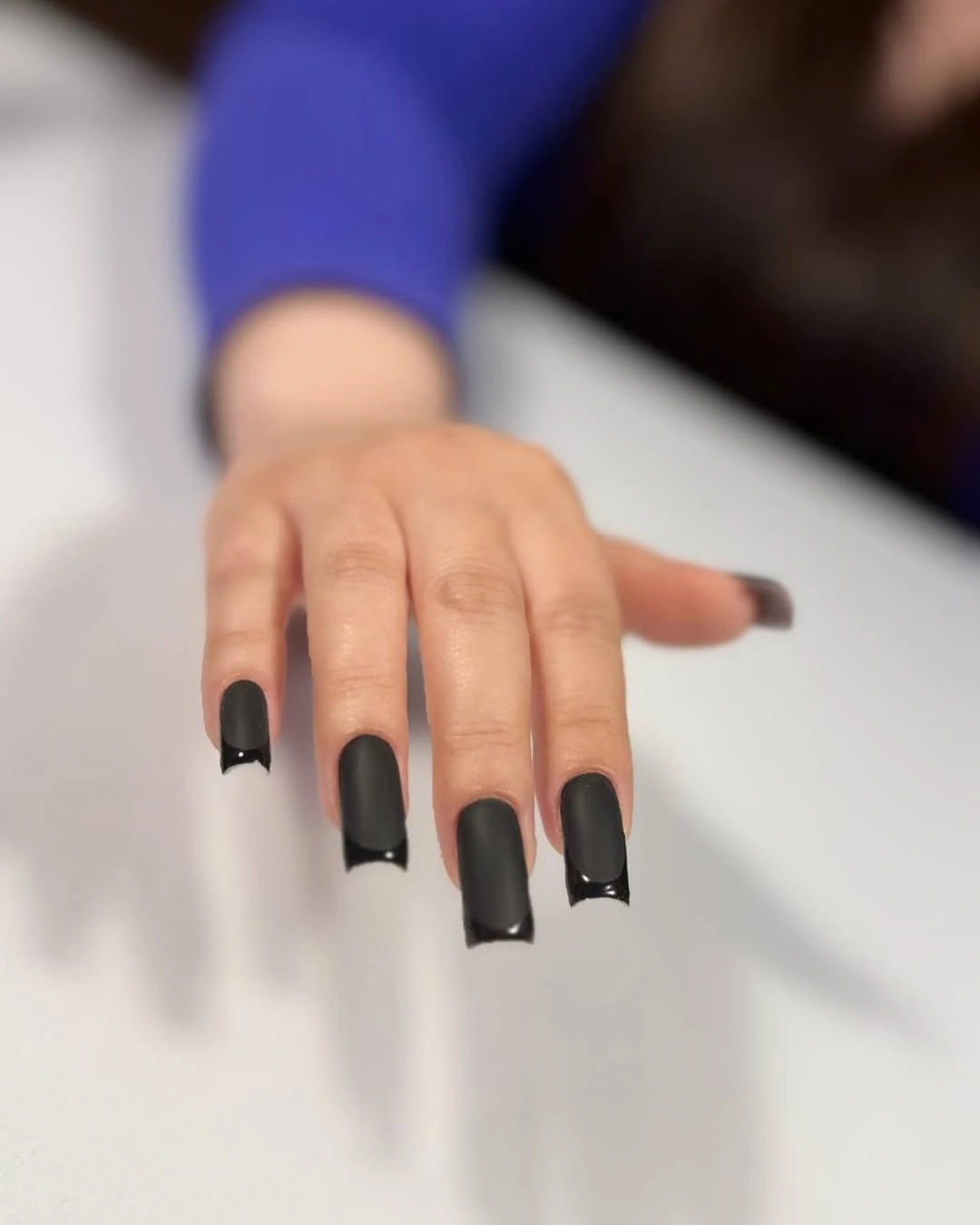 Long square nails with matte black centers and glossy black tips