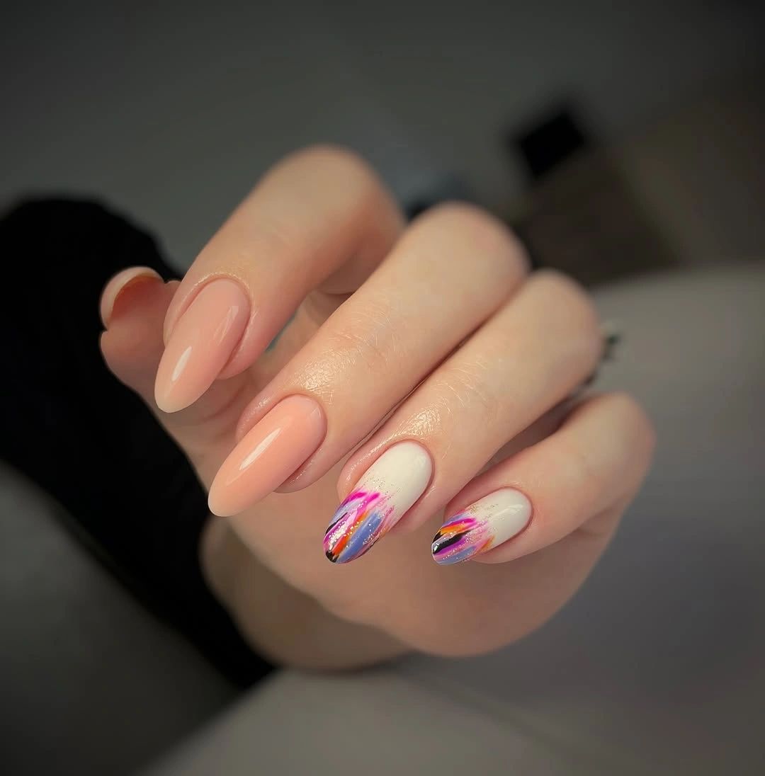 Peach nude almond nails with colorful diagonal accents