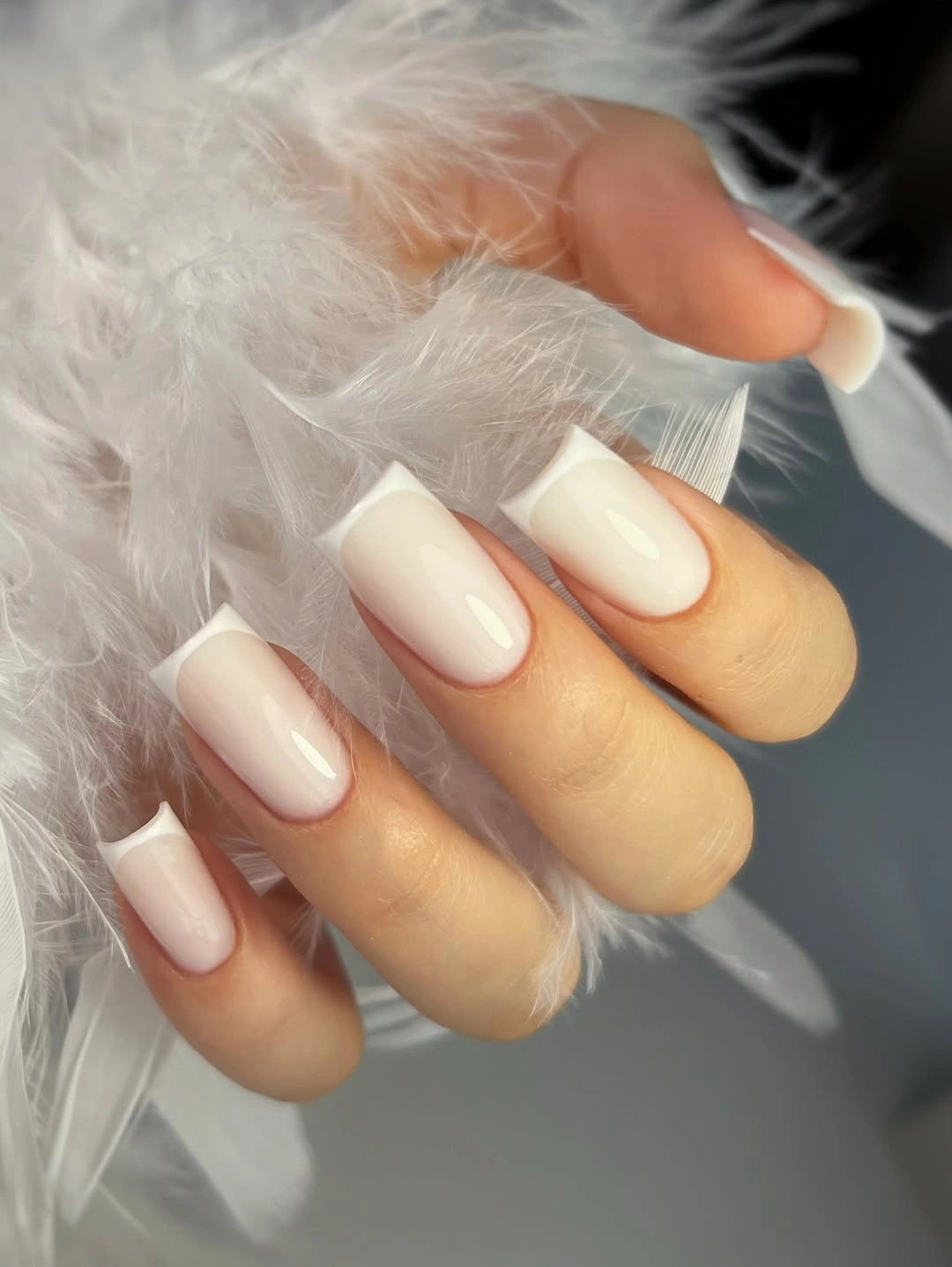 Long square nails with milky white bases and clean tips