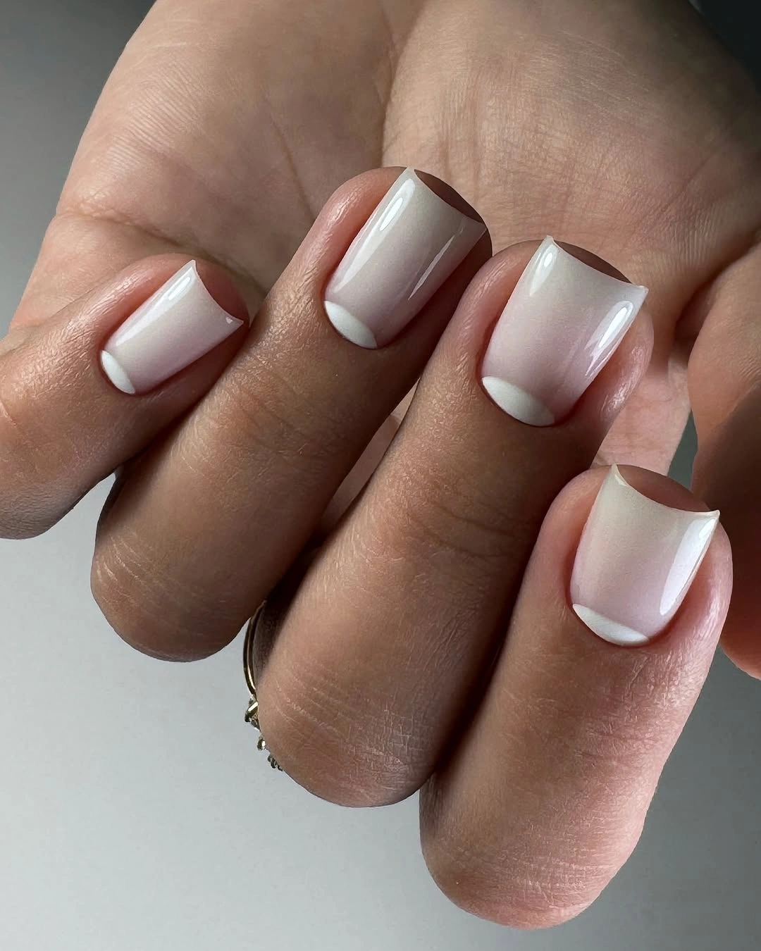 Short pale pink square nails with white cuticle crescents