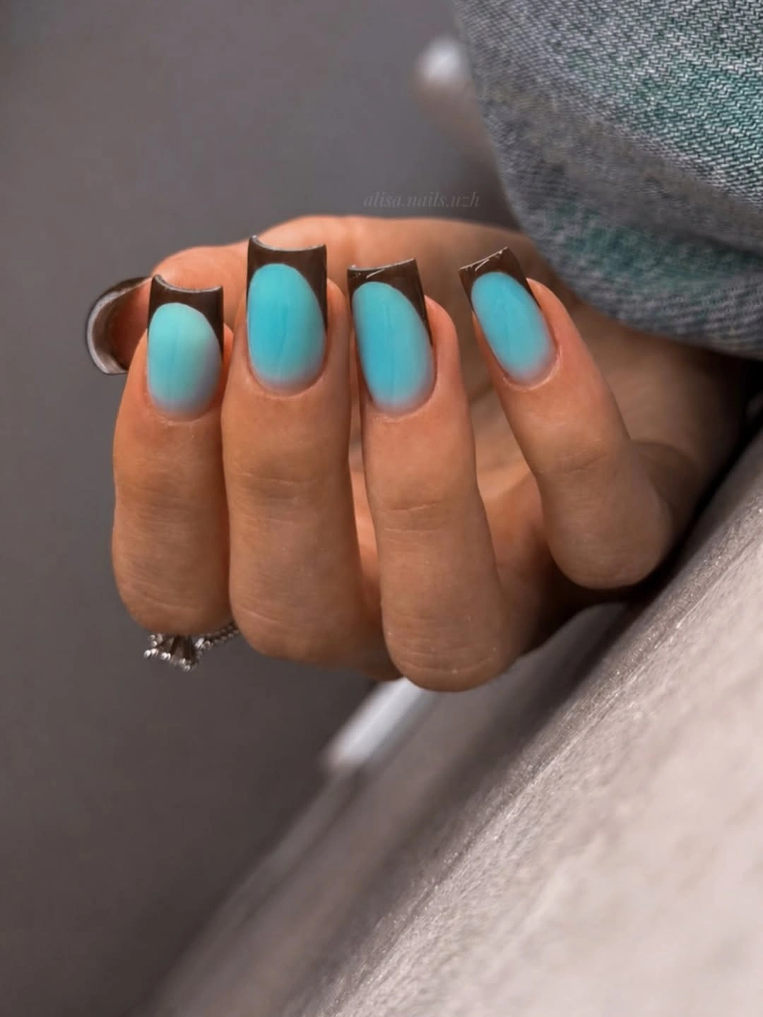 Short turquoise nails framed with deep brown contrast
